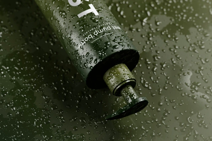 a close up of a water bottle on a wet surface printing and graphics by Since 90 Design
